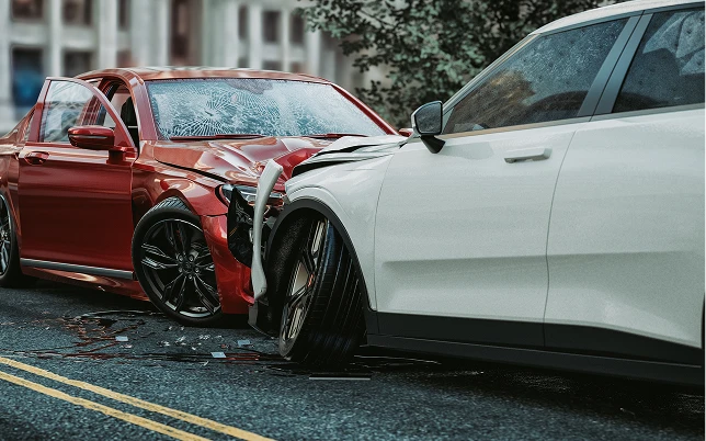 A red car with a shattered windshield and an open door crashed into a white car, scattering debris.