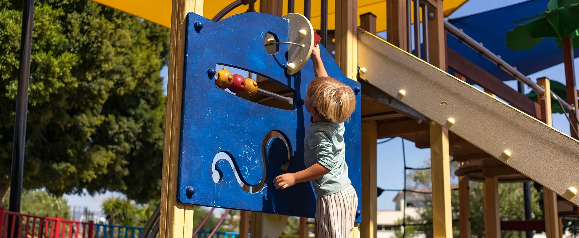 Young boy climbing on playground equipment representing a child injury claim