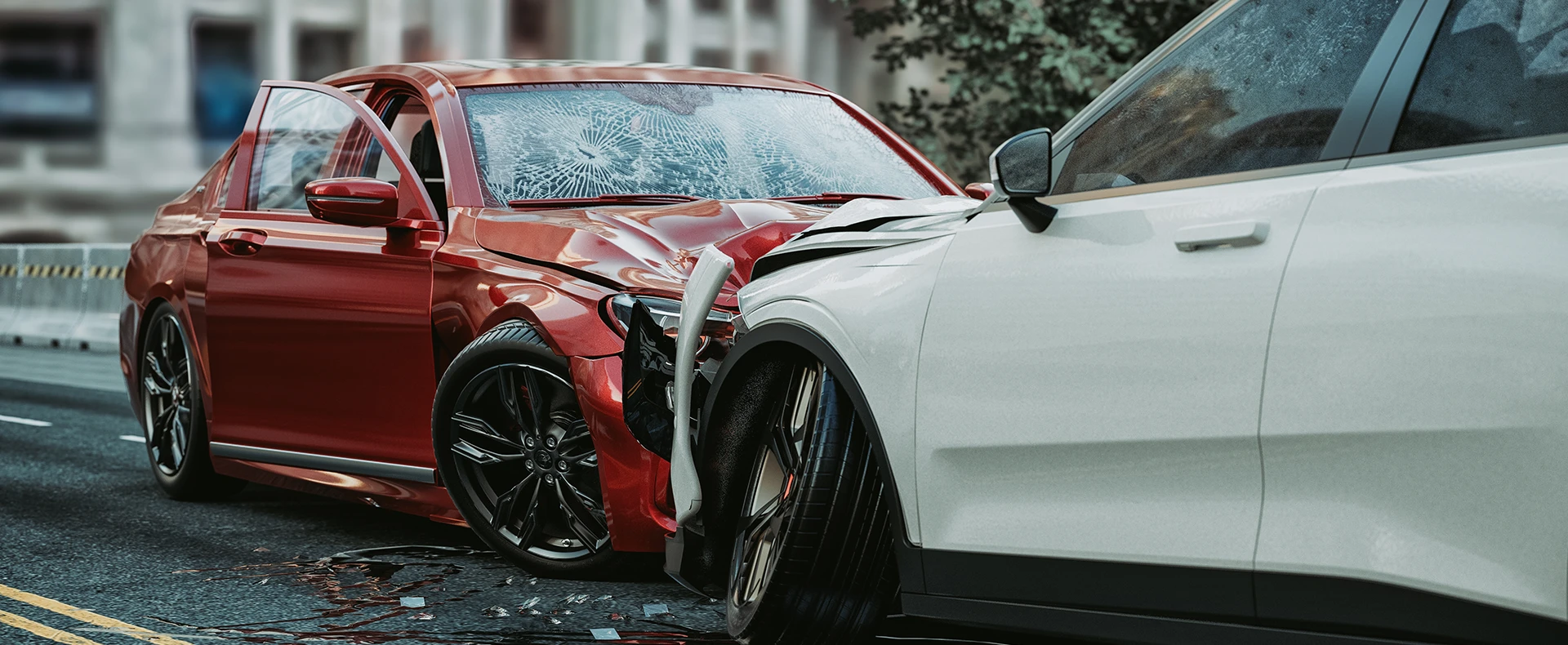 Damaged red sedan and white car involved in a severe traffic accident